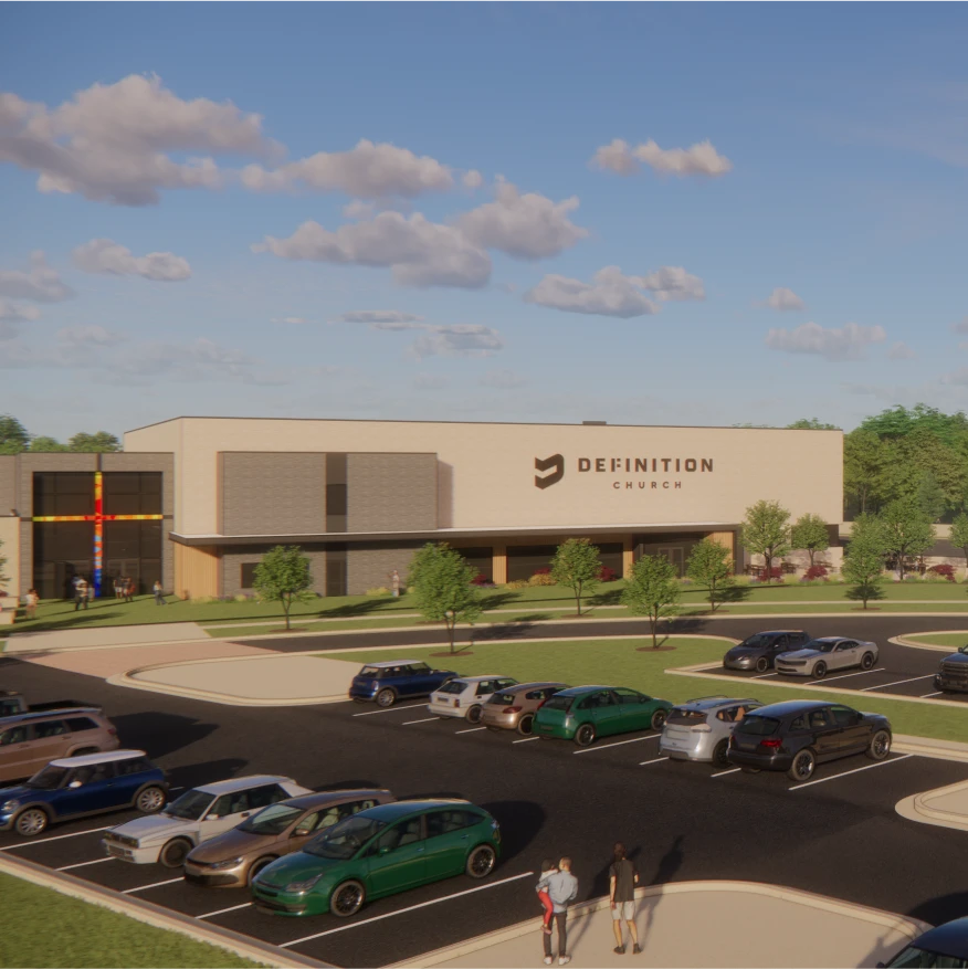 A modern building with "DEFINITION CHURCH" signage, surrounded by trees and a parking lot filled with cars, under a blue sky.